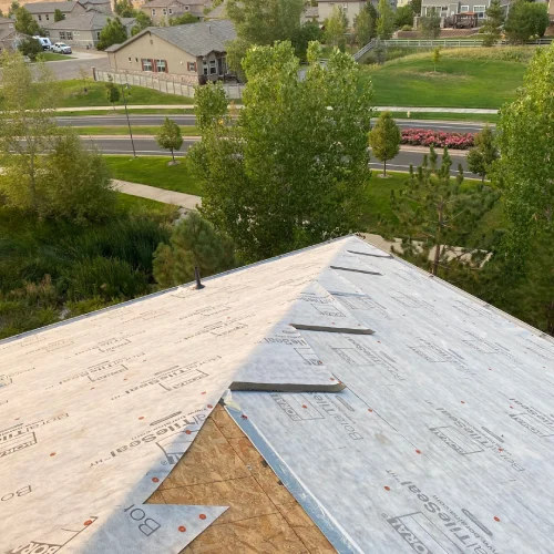 Roof decking covered with underlayment during residential roofing preparation by Mile High Roofing Services in Westminster, CO