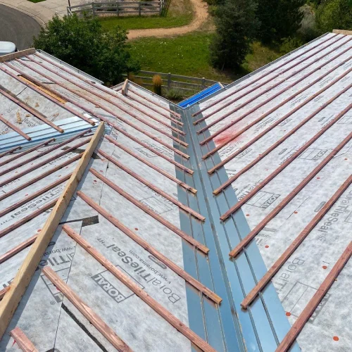 Roof valley with metal flashing and batten installation during residential roofing by Mile High Roofing Services in Westminster, CO