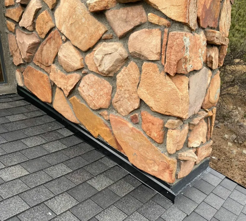 New flashing installed around a chimney during residential roof repair in Westminster, CO.