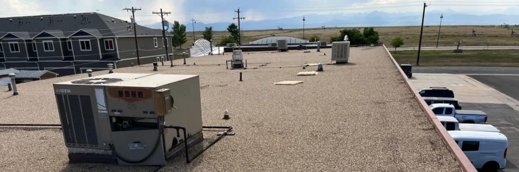 Flat commercial roof with HVAC during inspection — commercial roof replacement guide by Mile High Roofing Services in Westminster, CO