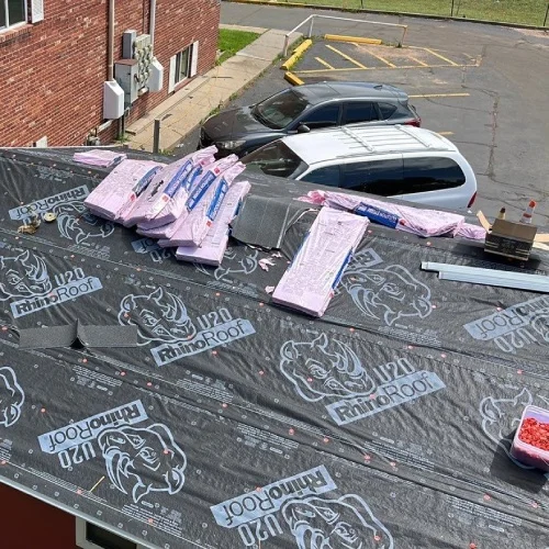 Roof deck with RhinoRoof underlayment and staged materials — commercial roof replacement guide by Mile High Roofing Services in Westminster, CO