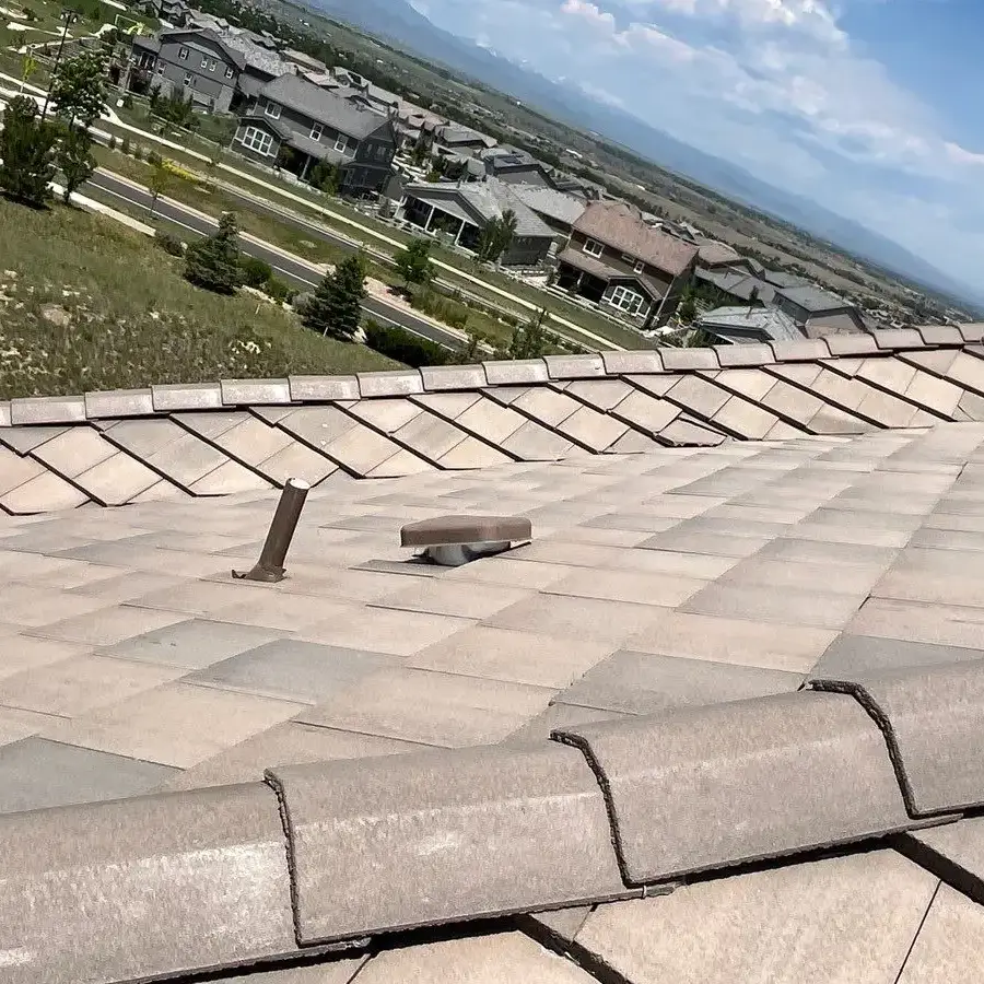 Concrete tile roof replacement results for roofing referral program by Mile High Roofing Contractor Westminster CO Wide view of concrete tile roof surface and ridge line after roof replacement for roofing referral program by Mile High Roofing Contractor Westminster CO