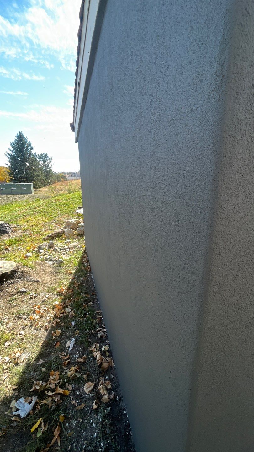 Close‑up of a smooth stucco wall section showing freshly finished exterior surface in westiminster, co