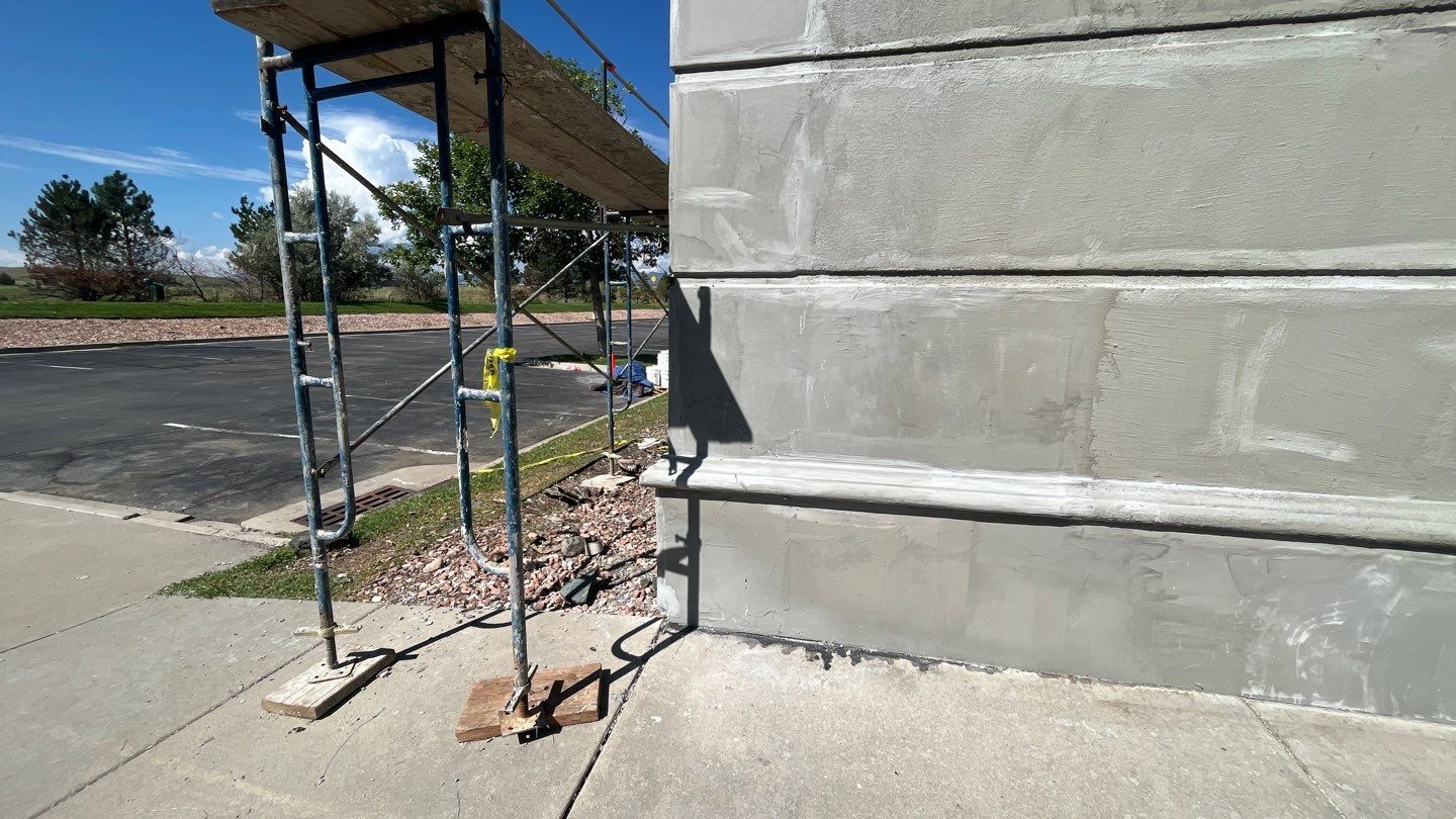 Scaffolding and workers’ tools positioned along a tall building wall during exterior repair in westiminster, co