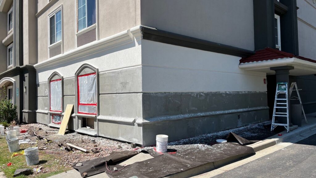Building corner under repair with construction materials and a bucket placed nearby in westiminster, co