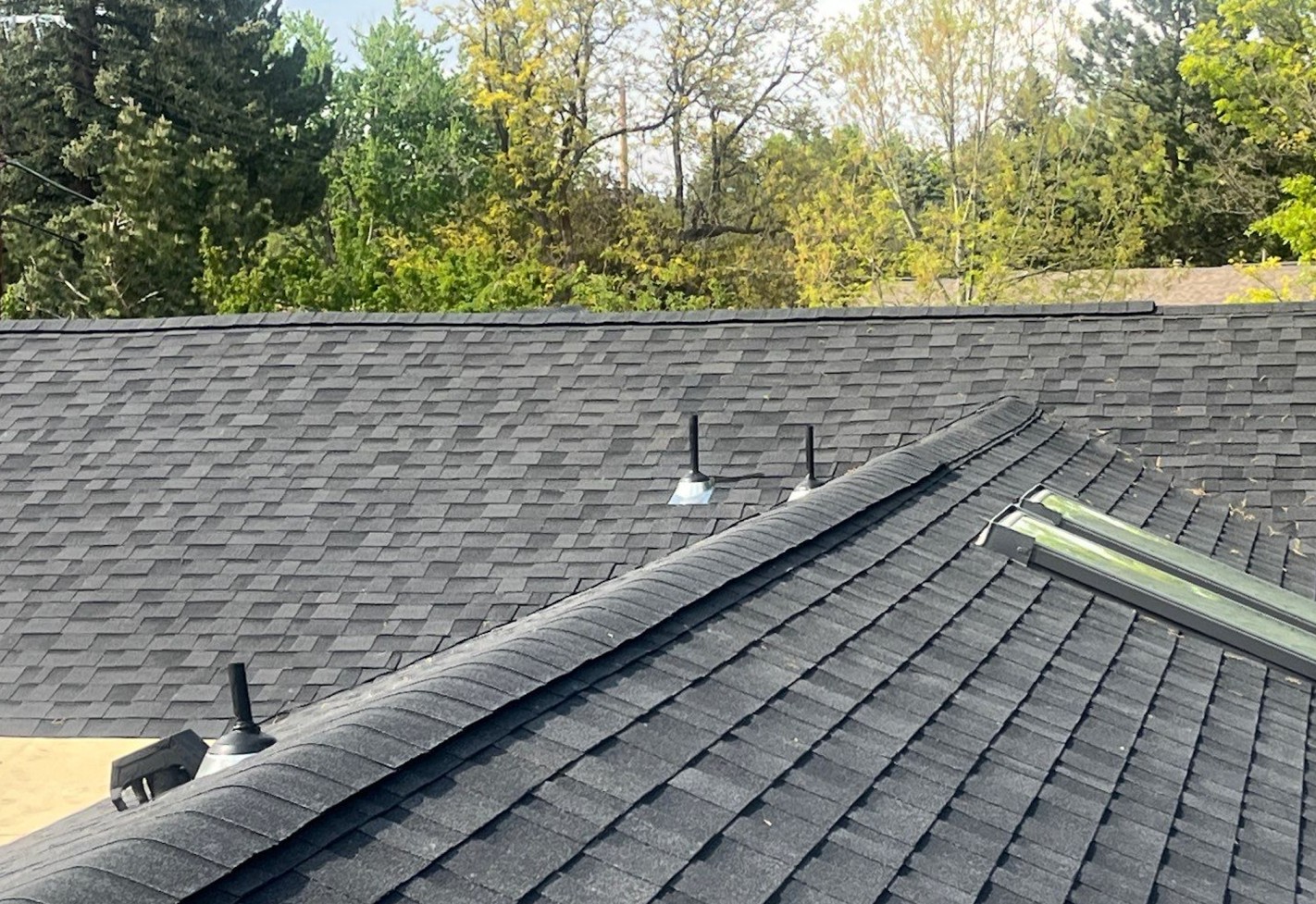 Wide view of concrete tile roof surface and ridge line after roof replacement for roofing referral program by Mile High Roofing Contractor Westminster CO